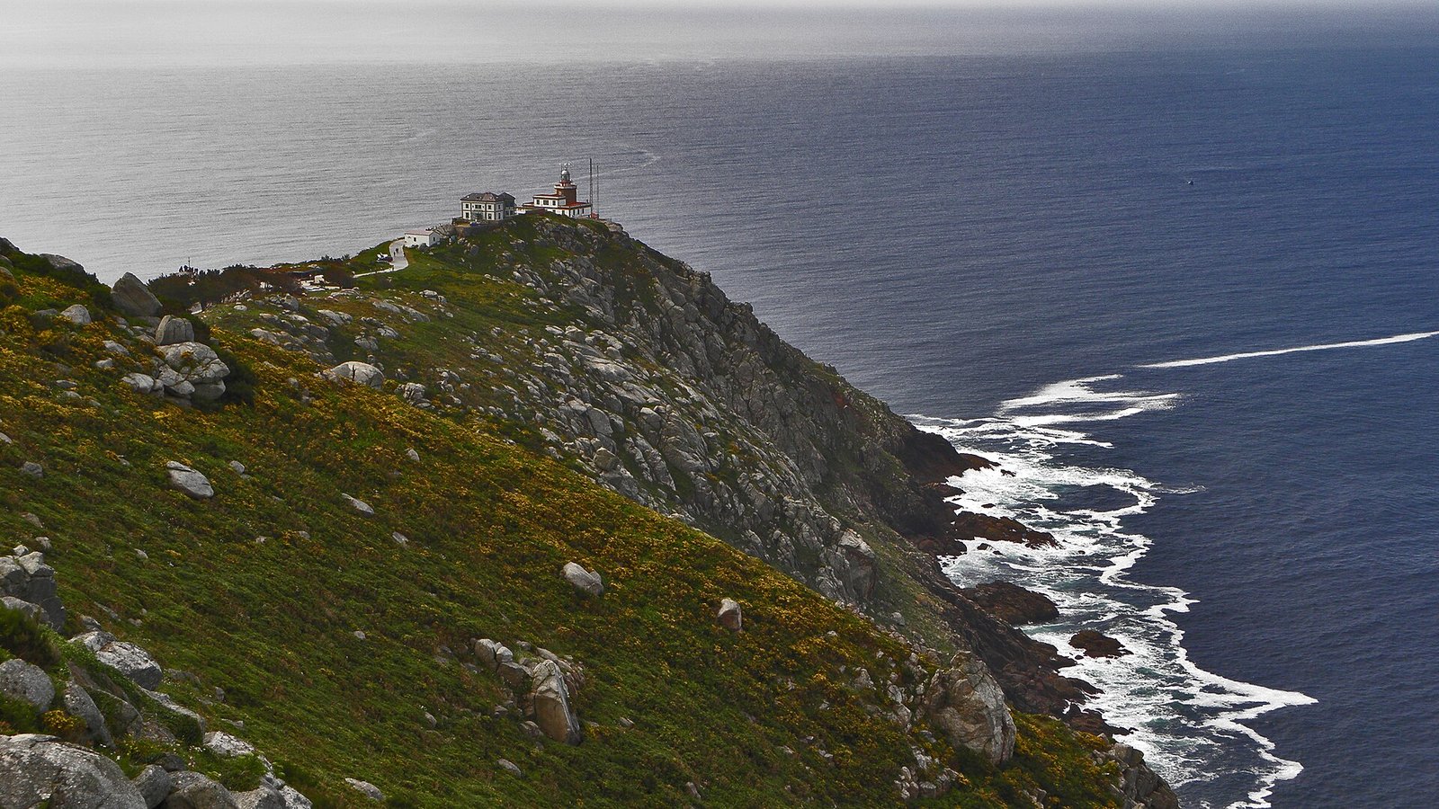 Camino Finisterre: the lighthouse on the cliffs of Cape Fisterra above the Atlantic, Galicia
