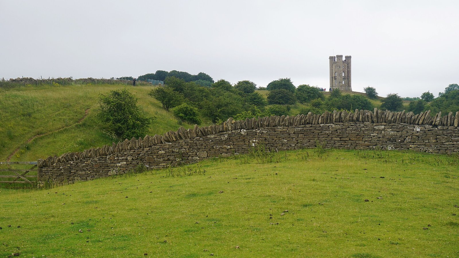 Cotswold Way: the path along a dry-stone wall towards Broadway Tower on the Cotswold escarpment above Broadway