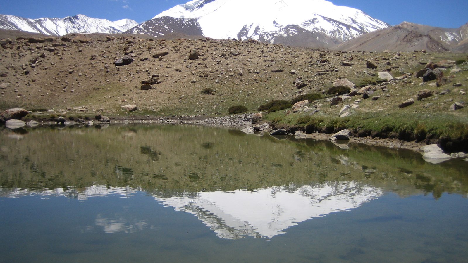Markha Valley Trek: snow-capped Kang Yatse reflected in a small lake near Nimaling, Hemis National Park, Ladakh, India